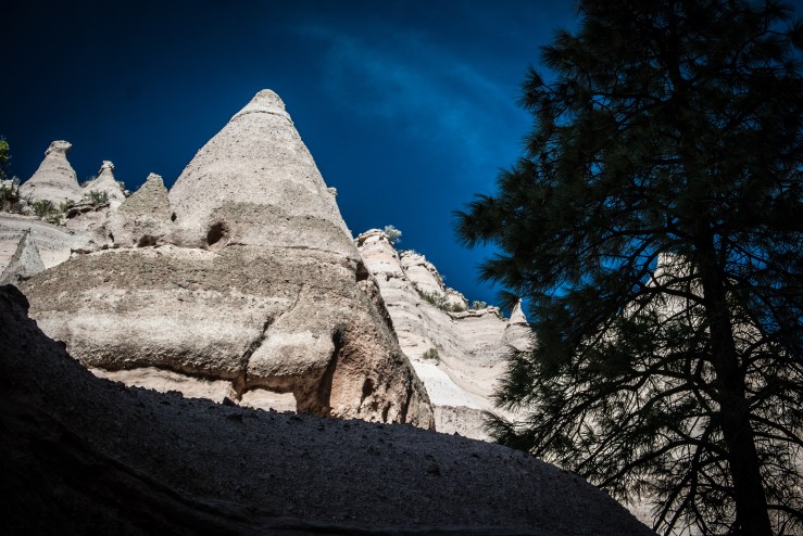 Tent rocks! From the Bureau of Land Management website: "The cone-shaped tent rock formations are the products of volcanic eruptions that occurred 6 to 7 million years ago and left pumice, ash, and tuff deposits over 1,000 feet thick. Tremendous explosions from the Jemez volcanic field spewed pyroclasts (rock fragments), while searing hot gases blasted down slopes in an incandescent avalanche called a “pyroclastic flow.”"